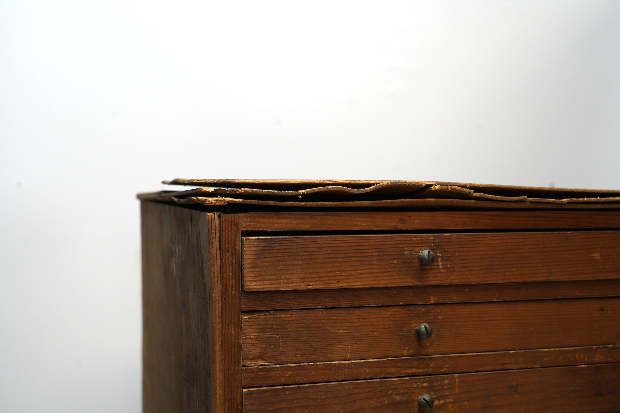 A wooden twelve drawer cabinet containing a collection of watch parts. Condition - cabinet fair to good, watch parts as found
